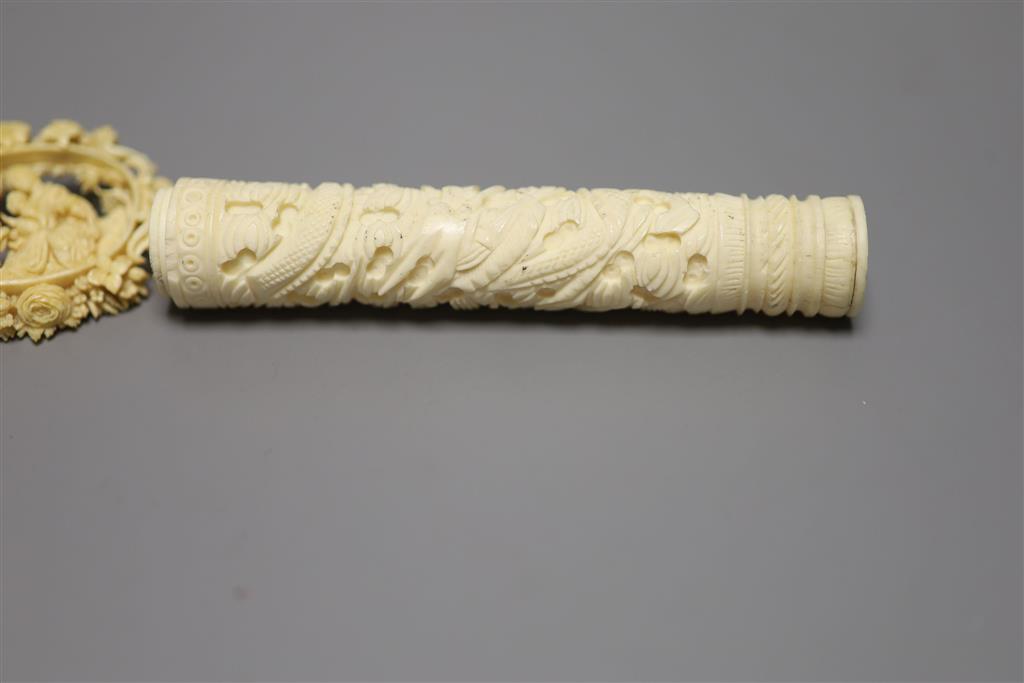 A 19th century carved ivory needlecase, length 15cm, and a brooch